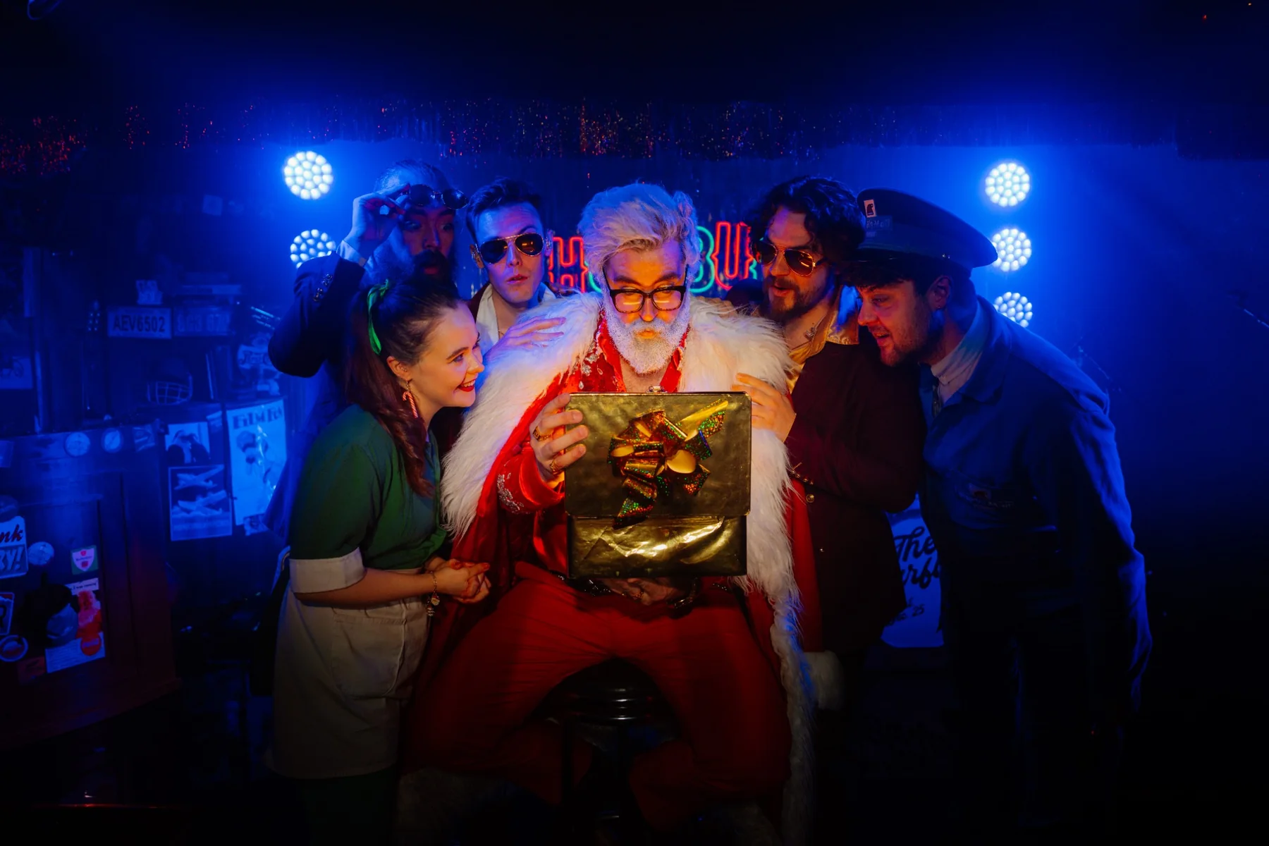Santa surrounded by performers at Humbug